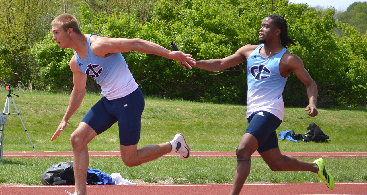 Two Male Track Athletes Running Relay